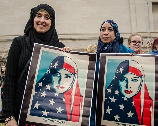 Two women holding frames